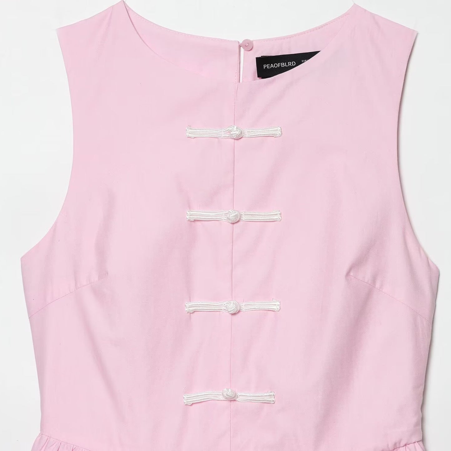 Sleeveless knot buckle embellished short skirt style hem top